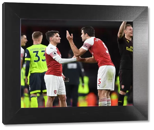 Arsenal Duo Lucas Torreira and Sokratis Celebrate Victory Over Huddersfield Town