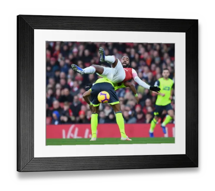 Framed Print : Intense Face-off: Lacazette vs. Jorgensen in Arsenal's Premier League Battle