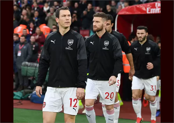Arsenal's Lichtsteiner and Mustafi in Action against Huddersfield Town