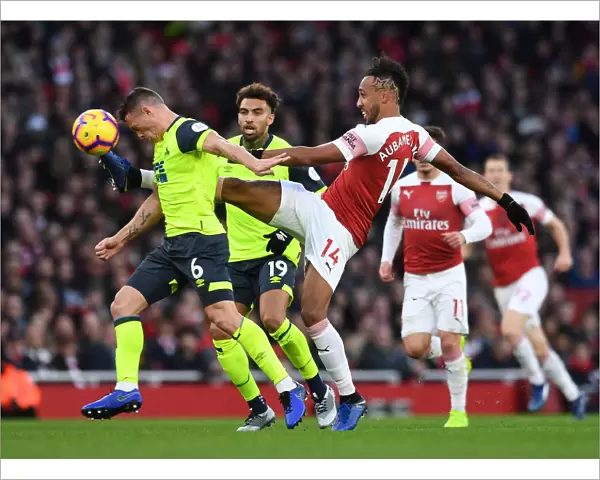 Arsenal's Aubameyang Clashes with Huddersfield's Hogg in Premier League Showdown