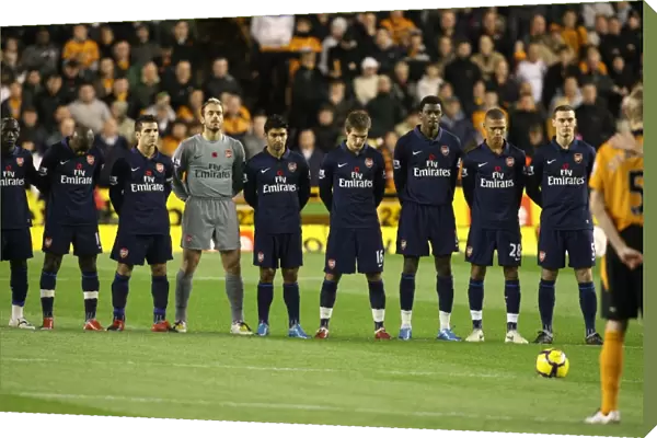 The Arsenal and Wolves teams observe a minutes silence