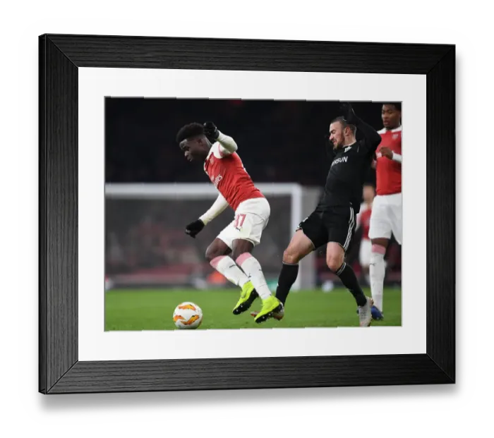 Framed Print : Arsenal's Saka Drives Past Qarabag's Gara Gareyev in Europa League Clash Framed Print : Arsenal's Saka Drives Past Qarabag's Gara Gareyev in Europa League Clash