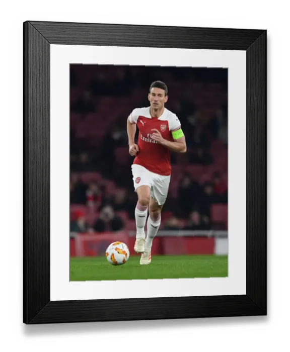 Framed Print : Arsenal's Koscielny Focuses Amidst Europa League Battle Against Qarabag Framed Print : Arsenal's Koscielny Focuses Amidst Europa League Battle Against Qarabag