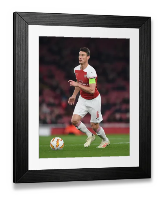 Framed Print : Arsenal's Koscielny Concentrates in Europa League Battle against Qarabag
