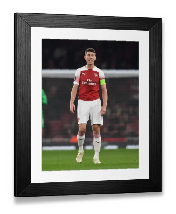 Framed Print : Focused Koscielny: Arsenal's Unyielding Defender in Europa League Battle Against Qarabag Framed Print : Focused Koscielny: Arsenal's Unyielding Defender in Europa League Battle Against Qarabag