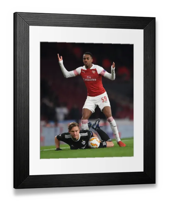 Framed Print : Arsenal's Joe Willock Intimidates Qarabag's Jakub Rzezniczak in Europa League Clash