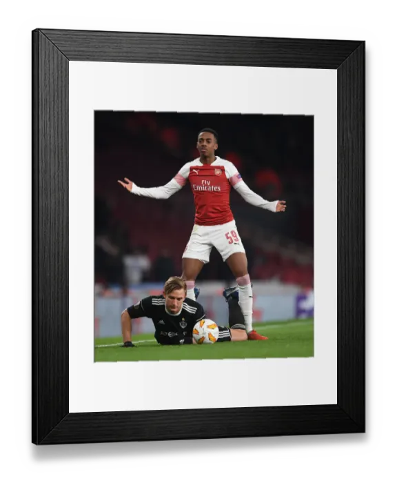 Framed Print : Arsenal's Joe Willock Stares Down Qarabag's Jakub Rzezniczak in Europa League Clash Framed Print : Arsenal's Joe Willock Stares Down Qarabag's Jakub Rzezniczak in Europa League Clash