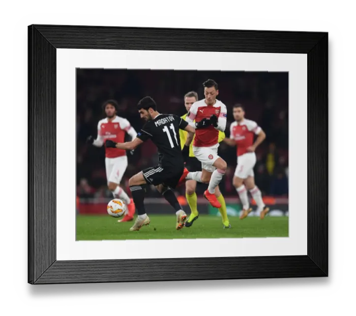 Framed Print : Mesut Ozil Outsmarts Mahir Madatov: Arsenal's Europa League Victory Framed Print : Mesut Ozil Outsmarts Mahir Madatov: Arsenal's Europa League Victory