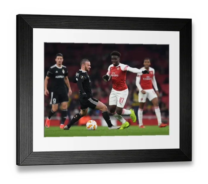 Framed Print : Arsenal's Rising Star Bukayo Saka Goes Head-to-Head with Qarabag's Defender Gara Gareyev in Europa League Showdown