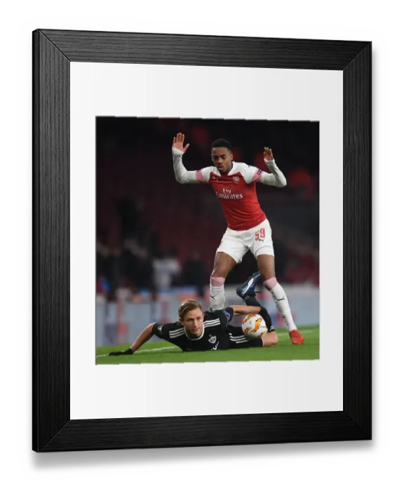 Framed Print : Arsenal's Joe Willock Intimidates Qarabag's Jakub Rzezniczak in Europa League Showdown Framed Print : Arsenal's Joe Willock Intimidates Qarabag's Jakub Rzezniczak in Europa League Showdown