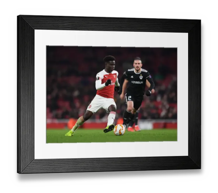 Framed Print : Arsenal's Bukayo Saka Goes Head-to-Head with Qarabag's Gara Gareyev in Europa League Battle Framed Print : Arsenal's Bukayo Saka Goes Head-to-Head with Qarabag's Gara Gareyev in Europa League Battle