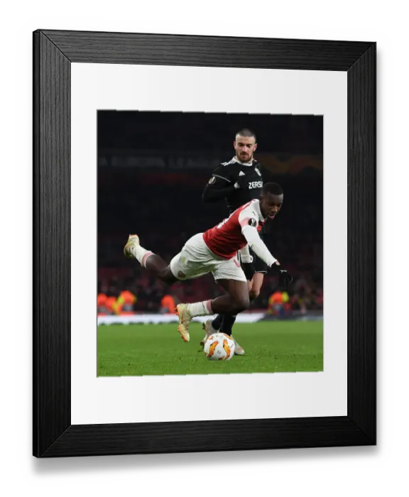 Framed Print : Arsenal's Eddie Nketiah Tripped by Qarabag's Maksin Medvedev during Europa League Clash Framed Print : Arsenal's Eddie Nketiah Tripped by Qarabag's Maksin Medvedev during Europa League Clash