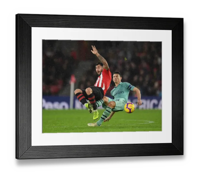 Framed Print : Clash at St. Mary's: Koscielny vs. Austin in Southampton v Arsenal Football Showdown