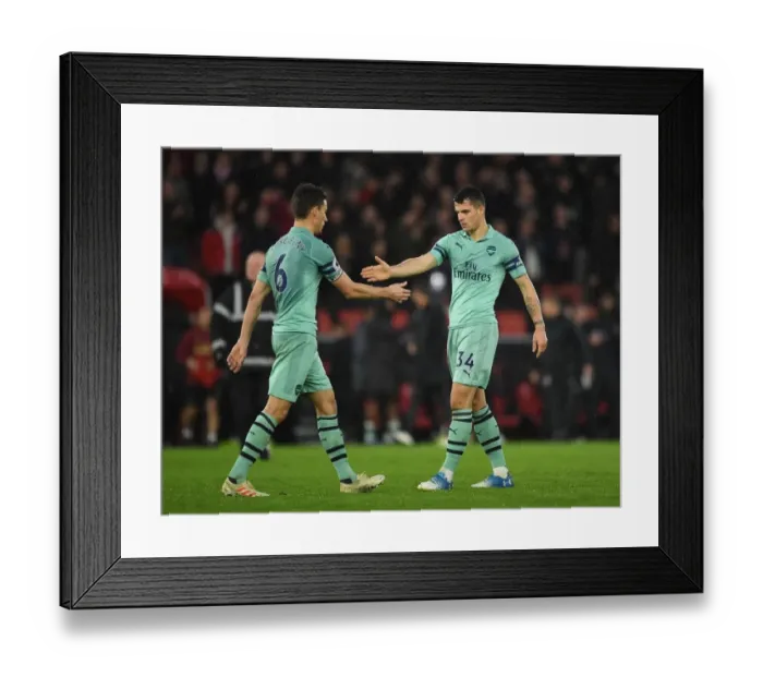 Framed Print : Celebrating Victory: Koscielny and Xhaka High-Five After Arsenal's Win Against Southampton (2018-19)
