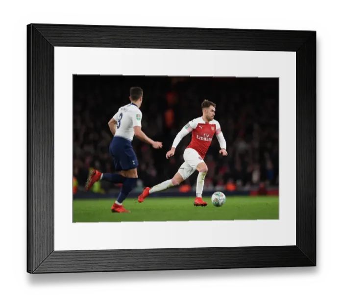 Framed Print : Arsenal's Aaron Ramsey: Unwavering Focus in Carabao Cup Clash Against Tottenham
