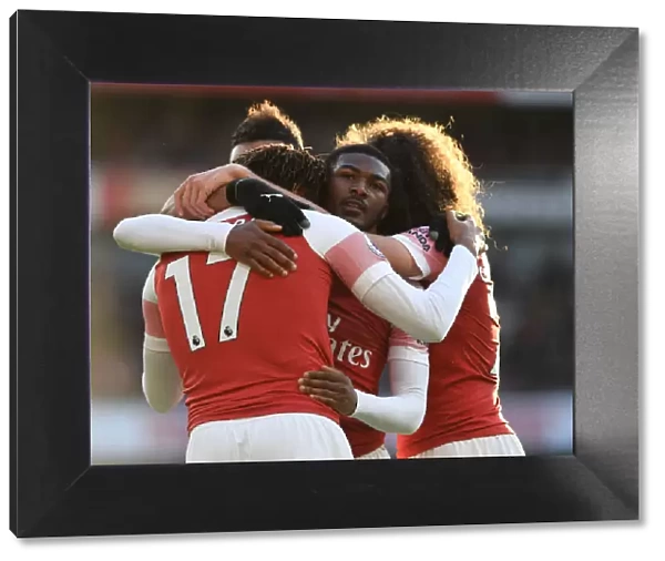 Celebrating a Goal: Iwobi and Maitland-Niles Rejoice after Arsenal's Third against Burnley