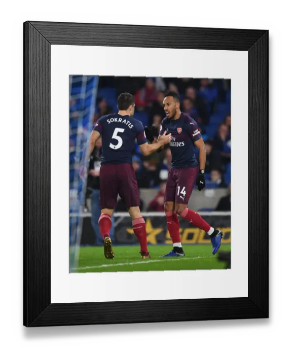 Framed Print : Aubameyang and Sokratis Celebrate Arsenal's Goal Against Brighton & Hove Albion