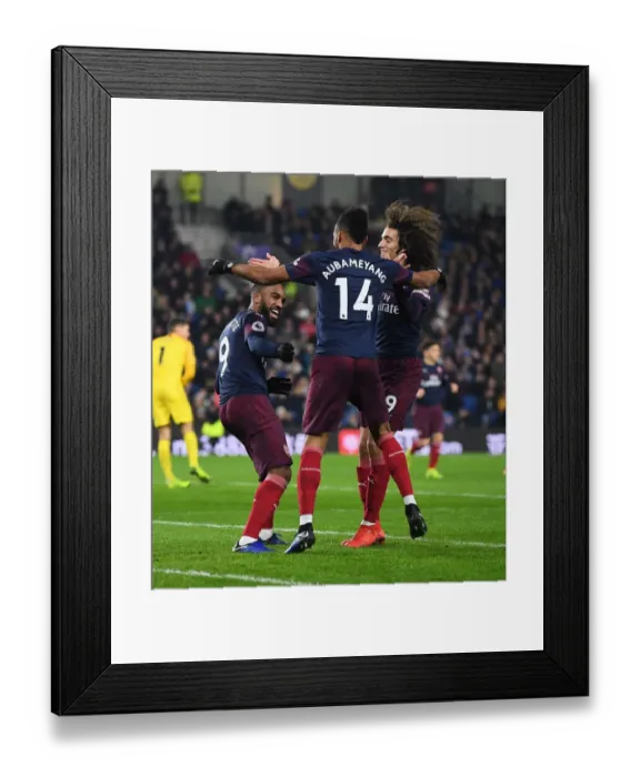 Framed Print : Arsenal's Triumph: Aubameyang, Lacazette, and Guebdouzi Celebrate Goal Against Brighton (December 2018)