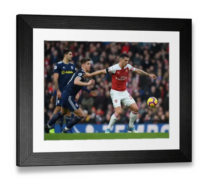 Framed Print : Arsenal's Granit Xhaka Fends Off Fulham's Tom Cairney in Premier League Clash