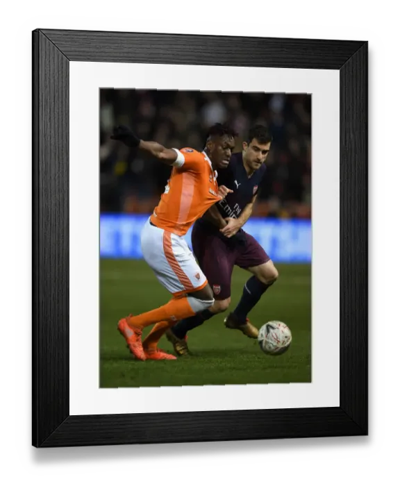 Framed Print : Sokratis vs Gnanduillet: Intense Clash in FA Cup Third Round between Blackpool and Arsenal Framed Print : Sokratis vs Gnanduillet: Intense Clash in FA Cup Third Round between Blackpool and Arsenal