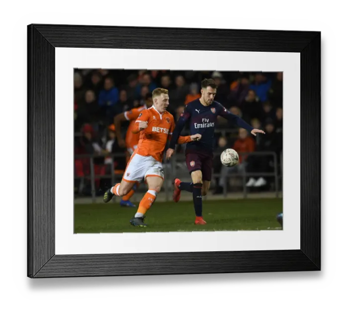 Framed Print : Arsenal's Aaron Ramsey Faces Off Against Blackpool's Callum Guy in FA Cup Clash Framed Print : Arsenal's Aaron Ramsey Faces Off Against Blackpool's Callum Guy in FA Cup Clash