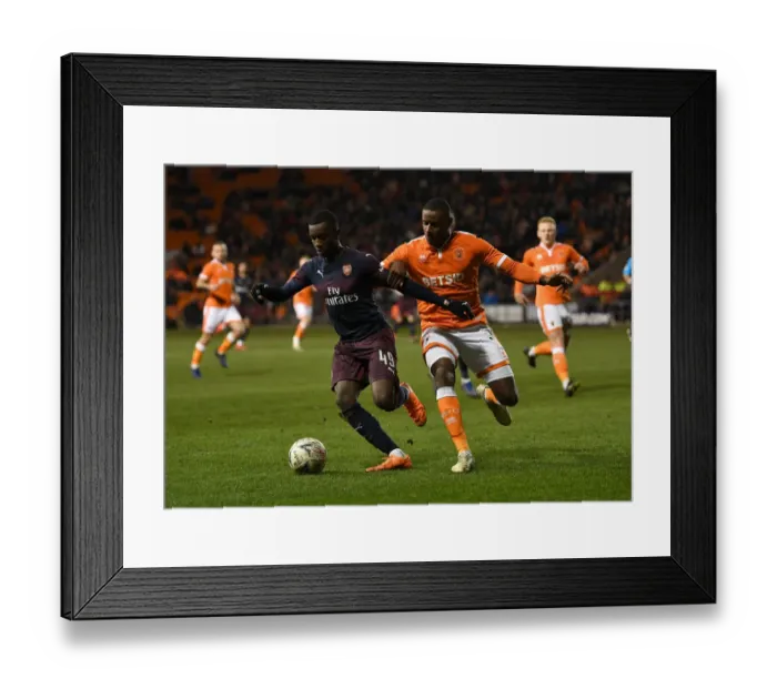 Framed Print : Arsenal's Eddie Nketiah Faces Off Against Blackpool's Donervon Daniels in FA Cup Clash