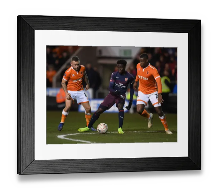Framed Print : Bukayo Saka Clashes with Blackpool Defenders in FA Cup Third Round Showdown