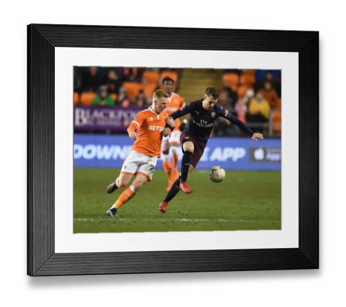 Framed Print : Arsenal's Aaron Ramsey Scores Past Blackpool's Callum Guy in FA Cup Third Round Framed Print : Arsenal's Aaron Ramsey Scores Past Blackpool's Callum Guy in FA Cup Third Round