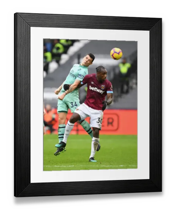Framed Print : Xhaka vs Antonio: Intense Clash Between West Ham and Arsenal in Premier League