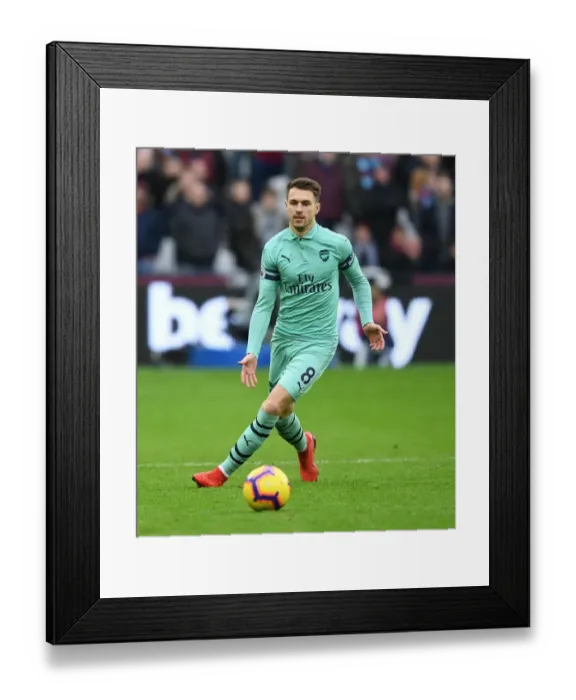 Framed Print : Arsenal's Aaron Ramsey Faces Off Against West Ham in Premier League Clash