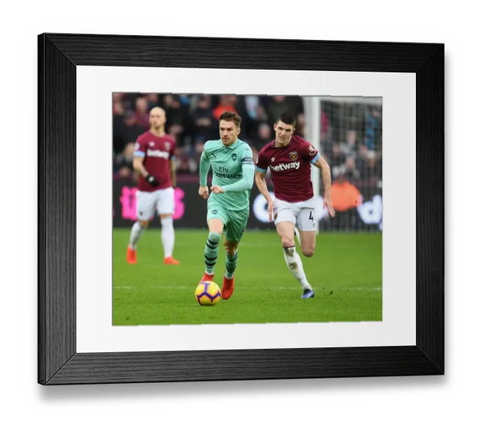 Framed Print : Ramsey Outsmarts Rice: Arsenal Star's Brilliant Maneuver in Premier League Clash Framed Print : Ramsey Outsmarts Rice: Arsenal Star's Brilliant Maneuver in Premier League Clash
