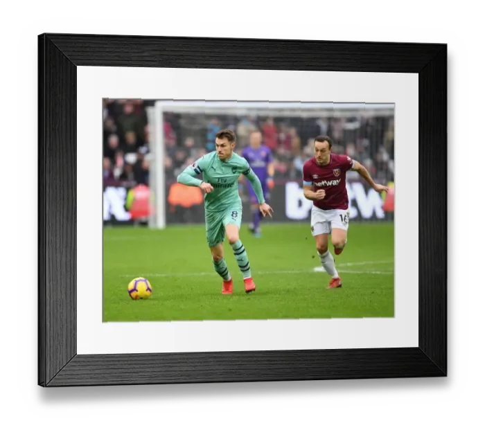 Framed Print : Arsenal's Aaron Ramsey Outmaneuvers West Ham's Mark Noble in Premier League Clash