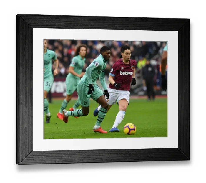 Framed Print : Ainsley Maitland-Niles vs Samir Nasri: Battle in the Premier League between West Ham and Arsenal