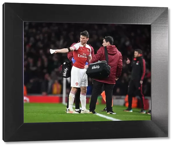 Arsenal's Koscielny Receives Medical Treatment from Doctor O'Driscoll during Arsenal vs Manchester United FA Cup Match