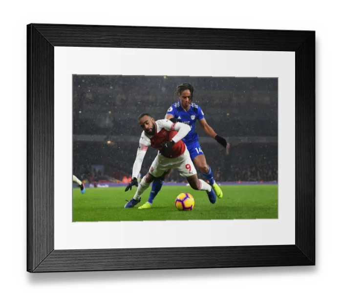 Framed Print : Arsenal's Lacazette Clashes with Cardiff's Reid in Premier League Showdown