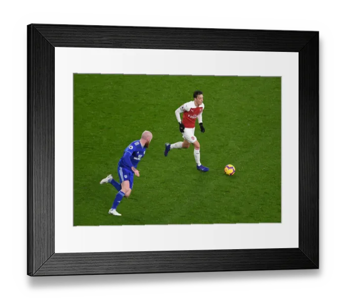 Framed Print : Arsenal's Mesut Ozil Faces Off Against Cardiff's Aron Gunnarsson in Premier League Clash Framed Print : Arsenal's Mesut Ozil Faces Off Against Cardiff's Aron Gunnarsson in Premier League Clash