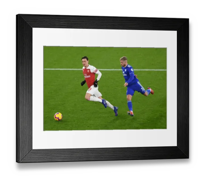 Framed Print : Intense Clash: Ozil vs. Bennett in Arsenal's Battle Against Cardiff Framed Print : Intense Clash: Ozil vs. Bennett in Arsenal's Battle Against Cardiff