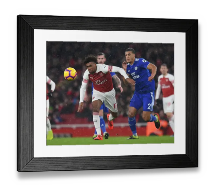 Framed Print : Arsenal vs. Cardiff: Iwobi Faces Off Against Peltier in Premier League Clash