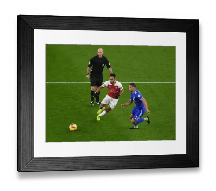 Framed Print : Arsenal's Aubameyang Faces Off Against Cardiff's Peltier in Premier League Clash