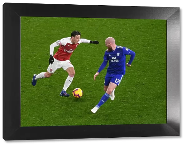 Arsenal's Mesut Ozil Clashes with Cardiff's Aron Gunnarsson in Premier League Showdown