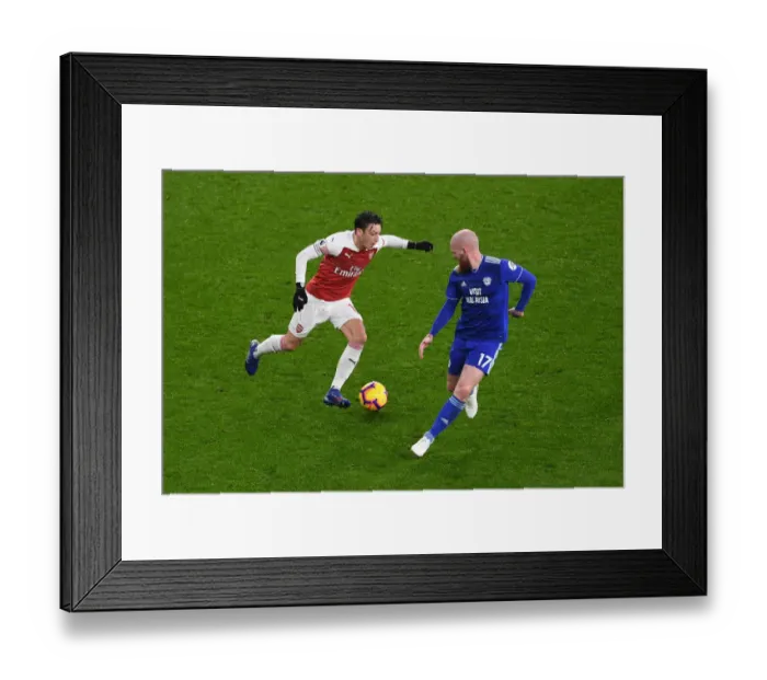 Framed Print : Arsenal's Mesut Ozil Clashes with Cardiff's Aron Gunnarsson in Premier League Showdown Framed Print : Arsenal's Mesut Ozil Clashes with Cardiff's Aron Gunnarsson in Premier League Showdown