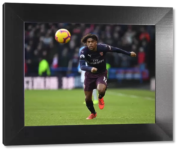 Arsenal's Alex Iwobi in Action Against Huddersfield Town in Premier League