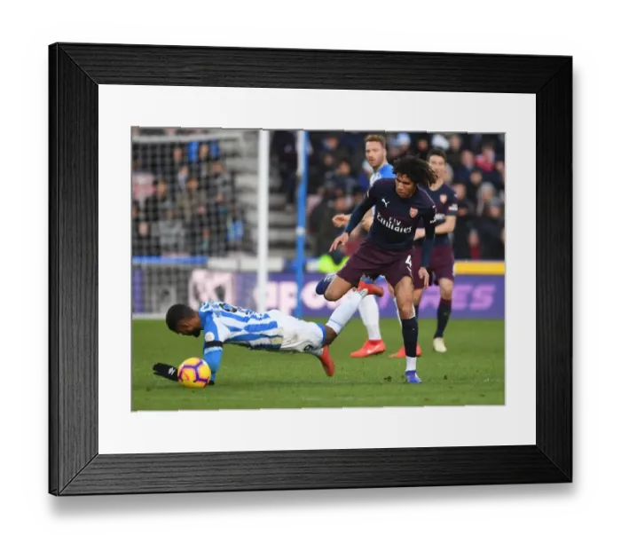 Framed Print : Arsenal's Mo Elneny vs. Huddersfield's Elias Kachunga: A Premier League Battle