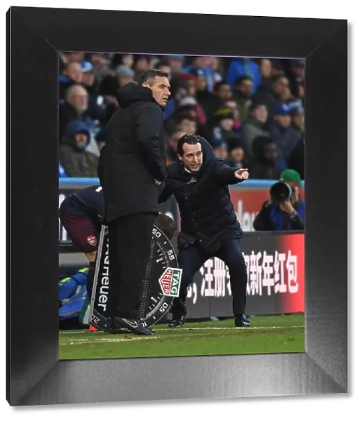 Unai Emery and Andre Marriner During Huddersfield vs Arsenal Premier League Match