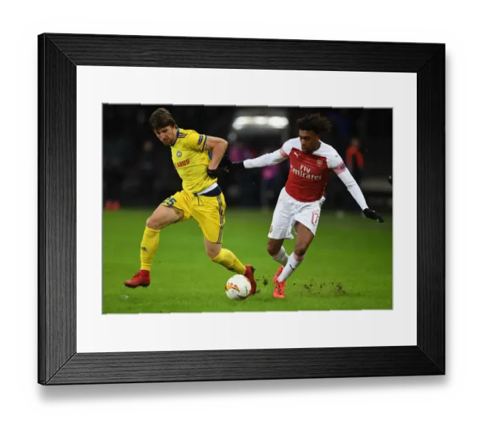 Framed Print : Arsenal's Alex Iwobi vs. Dmitri Baga: A Europa League Battle at BATE Borisov Framed Print : Arsenal's Alex Iwobi vs. Dmitri Baga: A Europa League Battle at BATE Borisov