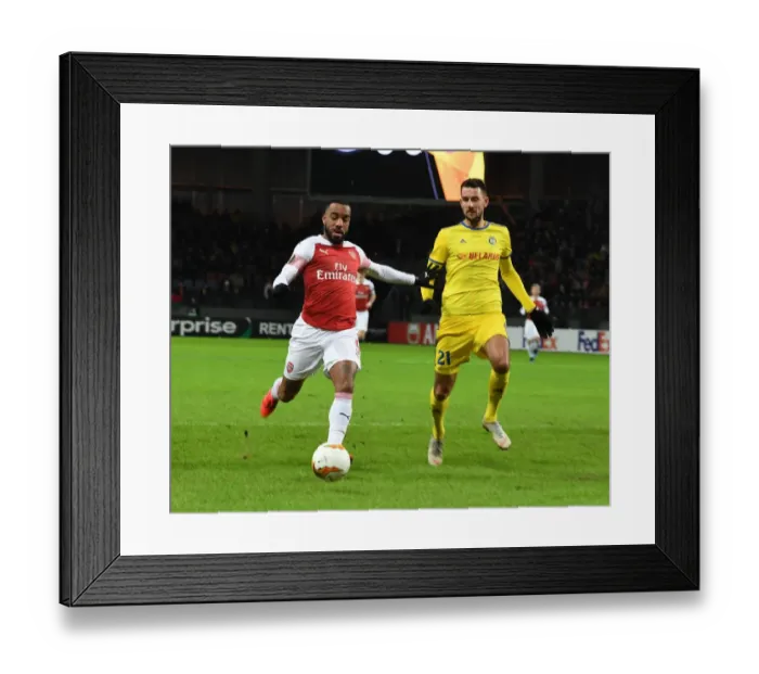 Framed Print : Arsenal's Alex Lacazette Faces Off Against BATE Borisov's Yegor Filipenko in UEFA Europa League Clash