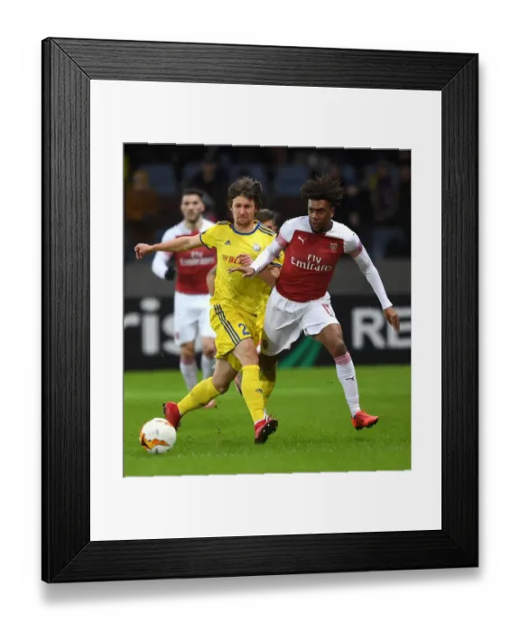 Framed Print : Arsenal's Alex Iwobi Faces Off Against BATE Borisov's Dmitri Baga in UEFA Europa League Clash