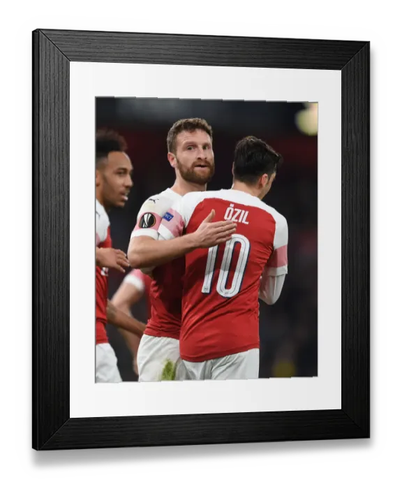 Framed Print : Arsenal's Mustafi and Ozil Celebrate Goals in Europa League Victory over BATE Borisov