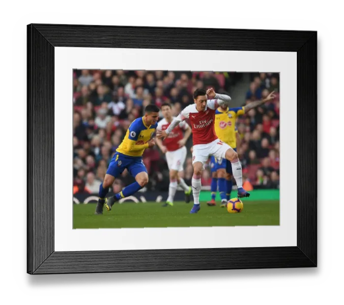 Framed Print : Ozil vs. Elyounoussi: A Battle of Skills in Arsenal vs. Southampton Premier League Clash