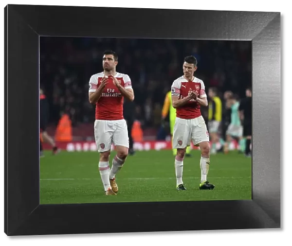 Arsenal's Sokratis and Koscielny Celebrate with Fans after Victory over Bournemouth